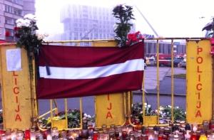 На месте трагедии повесили флаг Латвии в траурном оформлении