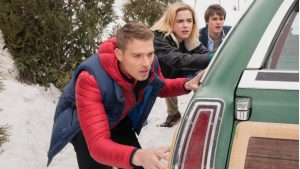 Кадр из фильма «Пусть идёт снег»: герои на фоне заснеженного города, атмосфера уюта, романтики и рождественского настроения.